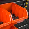 Close-up view of orange storage bins filled with screws, mounted on a black pegboard system. Anteprima dell’immagine prodotto