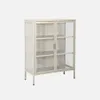 A beige metal cabinet with glass doors and shelves, shown against a white background. Produktbild-Vorschau