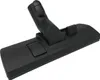 A close-up, studio shot of a black vacuum cleaner floor head attachment against a white background. Produktbild-Vorschau