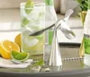 A bar setup with a drink, limes, lemons, and a bottle opener. Podgląd zdjęcia produktu