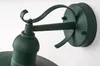 Close-up view of a dark green outdoor wall light fixture, showing the mounting bracket and part of the lamp head. Produktbild-Vorschau
