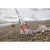 A trash grabber is picking up a plastic bottle and fishing net on a beach. Produktbild-Vorschau