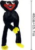 A black plush toy with yellow feet and hands, and a red mouth with white teeth and eyes. Produktbild-Vorschau
