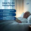 An elderly man is lying in bed, smiling. The image has text overlays describing product features. Produktbild-Vorschau