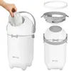 A hand is shown placing a diaper into a white and gray diaper pail. The diaper pail is shown in two views: one with a hand inserting a diaper, and another showing the assembled pail with its lid and a disassembled view of the lid components. Produktbild-Vorschau