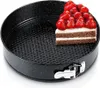 A slice of cake topped with strawberries sits inside a black springform pan. Náhled obrázku produktu