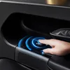 A close-up of a hand touching a glowing blue button on a car door panel. Voir les images du produit