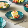 A table setting with plates of food and dessert. Produktbild-Vorschau