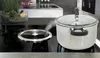 A pot of water is steaming on a modern induction stovetop with a built-in ventilation system. Podgląd zdjęcia produktu
