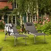 Two grey sun loungers are set up on a green lawn in front of a house with pink flowers. Náhled obrázku produktu