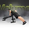 A man is performing a push-up on an adjustable workout bench, with the word "Volume" displayed in large, glowing yellow letters in the background. Náhľad obrázku produktu