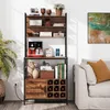 A multi-shelf storage unit with a coffee maker, books, wine bottles, and decorative items, placed next to a sofa in a living room. Produktbild-Vorschau