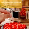 A hand is adjusting a ventilation hole on a grill, with chopped red chilies in the foreground. Produktbild-Vorschau