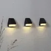 Three black solar wall lights mounted on a textured gray wall. Produktbild-Vorschau