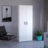 A white double-door wardrobe is shown in a room with a chair and a plant. Produktbild-Vorschau