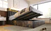 A bedroom scene featuring a bed with its storage compartment open, revealing the mattress support structure. The bed has a padded headboard with integrated LED lighting. Voir les images du produit