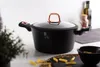 A black pot with rose gold handles and lid knob sits on a countertop, with pasta and a small bowl nearby. Náhled obrázku produktu