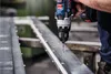 A person is using a Bosch drill to drill into a metal beam. Voir les images du produit