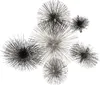 A collection of metallic, spiky decorative objects resembling dandelions or sea urchins, arranged in a cluster against a white background. Podgląd zdjęcia produktu