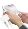 A person is holding a smartphone and using a white USB-C adapter to charge it and listen to audio. Náhled obrázku produktu
