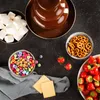 A chocolate fountain with various dipping items like marshmallows, strawberries, M&Ms, pretzels, and crackers arranged around it. Anteprima dell’immagine prodotto