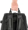 A hand holding the top handle of a backpack. Produktbild-Vorschau