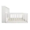 A white wooden crib with a built-in bookshelf is shown from the side against a white background. Produktbild-Vorschau
