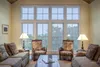 A living room with large windows overlooking trees. Anteprima dell’immagine prodotto