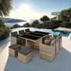A rattan dining set with black cushions is placed on a patio next to an infinity pool with a scenic ocean view. Náhled obrázku produktu