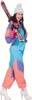 A woman in a colorful ski suit and hat holding skis. Produktbild-Vorschau