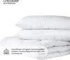 A stack of white pillows and a folded white blanket against a white background. Produktbild-Vorschau