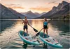 A man and a woman stand on paddleboards on a lake with mountains in the background during sunset. Náhled obrázku produktu