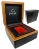 A wooden and black watch box with red interior, and a smaller black box in the background. Produktbild-Vorschau