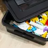A close-up view of a black storage box filled with colorful building blocks. Anteprima dell’immagine prodotto