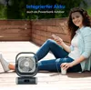 A woman is sitting on a wooden deck, using a smartphone and holding a cup, with a portable fan in front of her. Produktbild-Vorschau