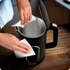 Hands cleaning the inside and outside of an electric kettle. Náhled obrázku produktu