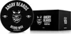 A black circular tin of beard wax and its black rectangular packaging are shown on a white background. Produktbild-Vorschau