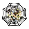 A black spiderweb-shaped bowl filled with Halloween-themed candy. Produktbild-Vorschau