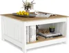 A square wooden coffee table with a white base and a wood-grain top, featuring an open shelf with books and decorative items. Anteprima dell’immagine prodotto
