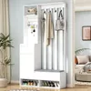 A white entryway storage unit with a bench and hooks, set against a light blue wall.