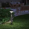 A solar garden light with a motion and dusk sensor is shown in a garden at night. Produktbild-Vorschau
