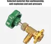 A close-up shot of a brass valve with a green handle against a light gray and white background. Podgląd zdjęcia produktu
