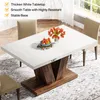A white dining table with a wooden base is shown in a dining room setting, with chairs around it. There is a vase of flowers and a bowl of fruit on the table. Anteprima dell’immagine prodotto