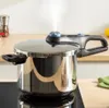 A pressure cooker on a stovetop with steam coming out. Produktbild-Vorschau