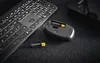 A close-up shot of a computer mouse with batteries being inserted, next to a keyboard. Anteprima dell’immagine prodotto