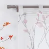 A close-up view of a window with a sheer curtain featuring a branch and leaf pattern, and a curtain rod. Produktbild-Vorschau