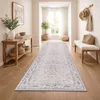 A hallway with a runner rug, console table, and bench. Anteprima dell’immagine prodotto