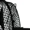 Close-up of a black wire mesh fan guard. Produktbild-Vorschau