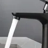 A close-up shot of a black faucet with water running. Náhľad obrázku produktu