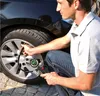 A man is checking the tire pressure of a car with a digital tire pressure gauge. Anteprima dell’immagine prodotto